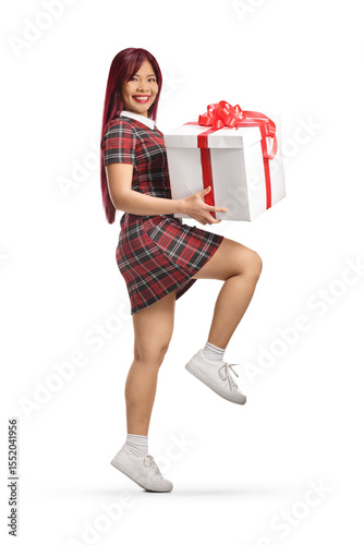 Asian female jumping and holding a present