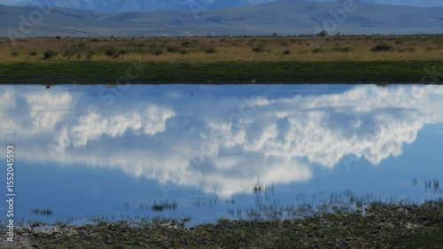 Video of Altai landscape in the Chuya steppe with small lake and mountains.  Zoom effect