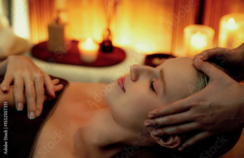 Wallpaper Mural Caucasian woman enjoying relaxing anti-stress head massage and pampering facial beauty skin recreation leisure in warm candle lighting ambient salon spa in luxury resort or hotel. Quiescent Torontodigital.ca