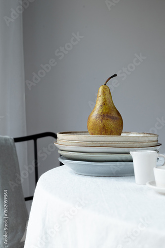 Organic pear on plate . Cozy kitchen aesthetic