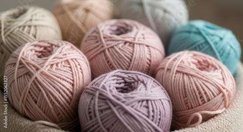 Close up of collection of several pastel colorful yarn balls, perfect for knitting and crochet projects. Craft supplies for handmade hobby for banner, poster, or presentation.