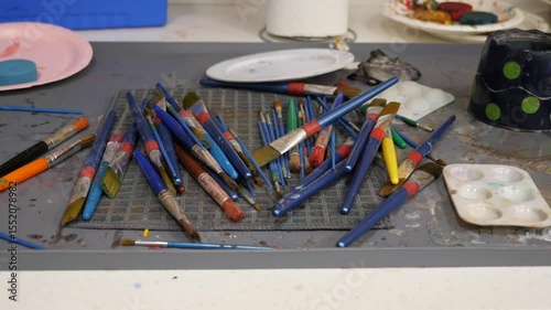 Art supplies clutter on a creative workspace
