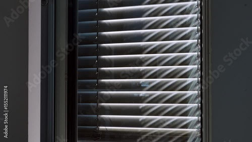 automated external blinds opening in a skyscraper office building