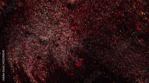 Video of deep red metallic texture flowing smoothly with sparkling highlights and rich color.