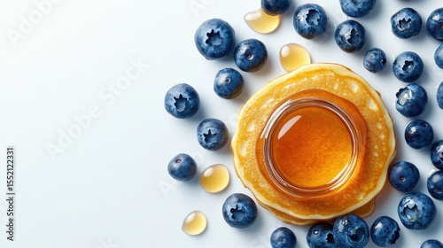 Top view breakfast pancakes with honey butter and blueberries on white background