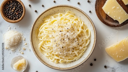 Top view carbonara pasta plate with creamy sauce and black pepper on white background