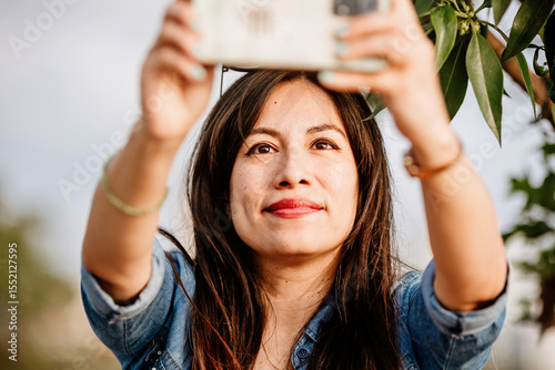 Young woman taking a selfie with cell phone