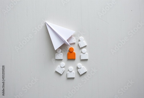 Paper airplane pointing at orange person icon on a white background