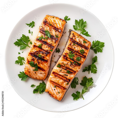 Two perfectly grilled salmon fillets seasoned with herbs and spices on a white plate isolated on transparent background