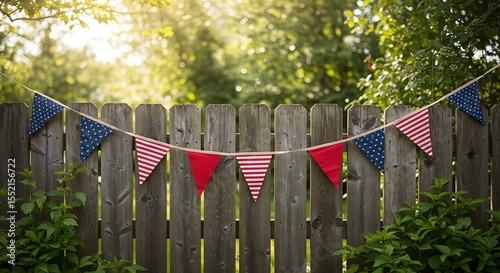White picket fence adorned with American star-patterned bunting on a sunny day.	