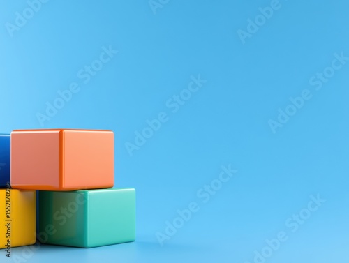 Colorful building blocks stacked neatly on a blue background representing creativity and design.