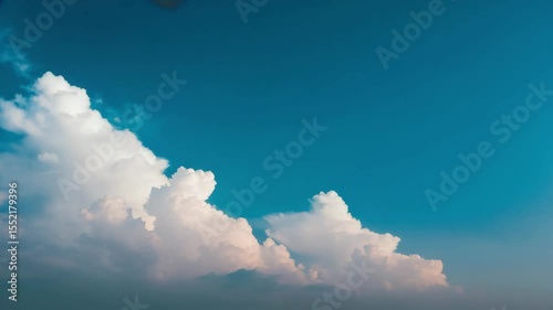 Beautiful white clouds in a clear blue sky over a tranquil landscape during the afternoon