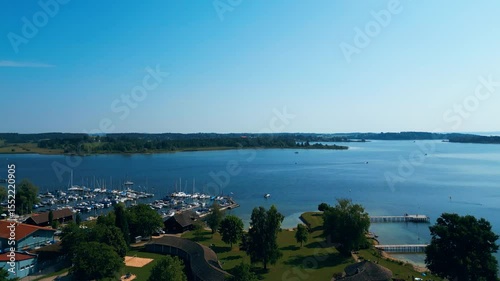 Aerial view of Prien am Chiemsee, a charming Bavarian town on the shore of Lake Chiemsee. Captured in summer, perfect vacation vibes with clear water, green landscapes, and sunny weather