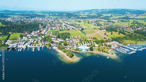 Aerial view of Prien am Chiemsee, a charming Bavarian town on the shore of Lake Chiemsee. Captured in summer, perfect vacation vibes with clear water, green landscapes, and sunny weather