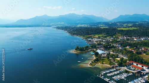 Aerial view of Prien am Chiemsee, a charming Bavarian town on the shore of Lake Chiemsee. Captured in summer, perfect vacation vibes with clear water, green landscapes, and sunny weather