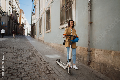 Young Asian woman driving e scooter and exploring town