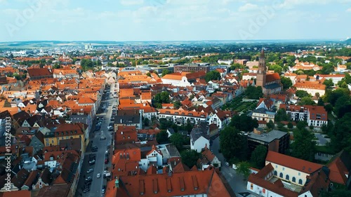 Landshut, a vibrant Bavarian town, viewed from the air. Features the medieval Trausnitz Castle on a hill and the striking Church of St. Martin with the tallest brick tower in the world