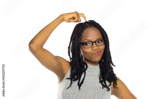 Fotografía Black woman with glasses scratching head and looking uncertain, studio shot on white background