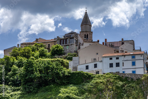 Panoramic view of the old town of Vrbnik with the clock tower against the blue sky,