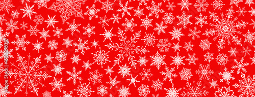 A vibrant Christmas illustration featuring various intricate snowflakes of varying sizes and designs, white on red background.