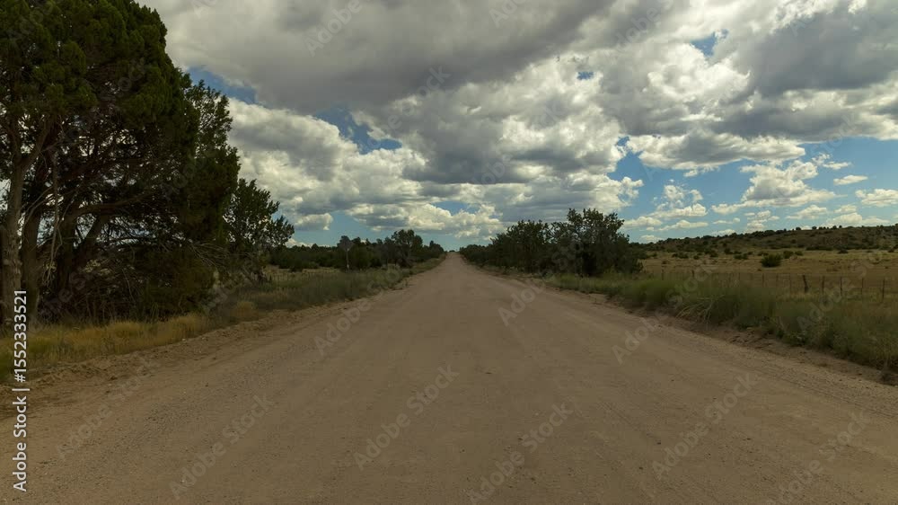 Time lapse of clouds over a dirt road. Time lapse of clouds over a dirt road.