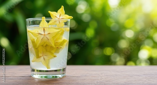 Fresh Starfruit Decoration in Clear Glass with Natural Green Background and Soft Light Highlights