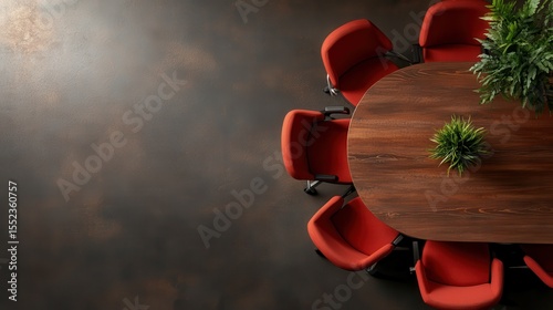 An overhead shot of a round conference table with red chairs, emphasizing a collaborative atmosphere ideal for meetings and discussions in a modern office environment.
