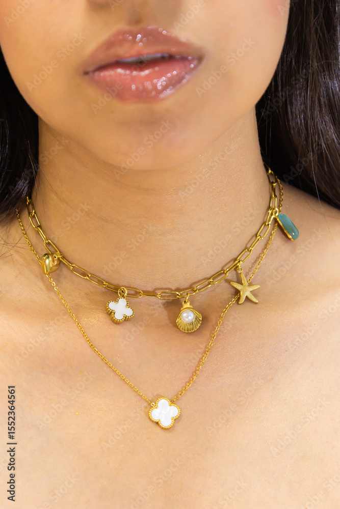 An unrecognizable woman wears a gold necklace inside a photo studio in Neiva, Huila, Colombia. Beauty accessories concept An unrecognizable woman wears a gold necklace inside a photo studio in Neiva, Huila, Colombia. Beauty accessories concept