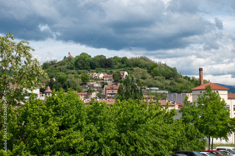 Obraz premium A cityscape with mountains of Olot, the capital city of the comarca of Garrotxa, in the Province of Girona, Catalonia, Spain