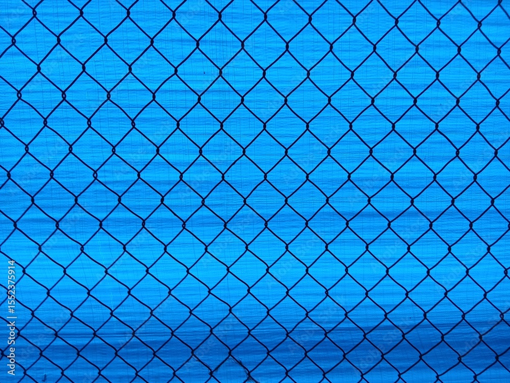 Fototapeta premium A simple, blue chain link wire fence background series. Perfect for digital designs, presentations and website backgrounds