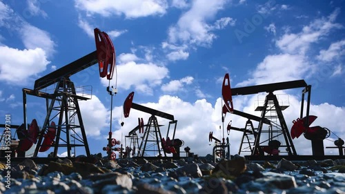 Oil Rig With Moving Cloud Background. Oil drilling derricks at desert oilfield. Crude oil production from the ground.