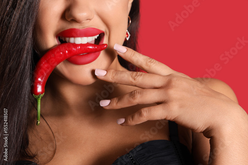Sexy young woman with chili...
