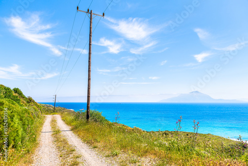 Horizon view of Samos island from dirt road footpath trail in Ikaria, Greece crystal clear water in Mediterranean in longevity blue zone
