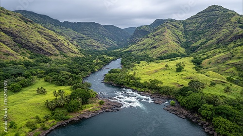 Lush valley with a winding river flowing through rolling hills.
