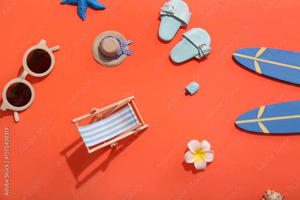 Naklejka premium Summer composition with decorative beach accessories on red background
