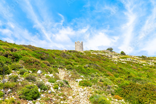 Drakano tower hiking trail path fence view of landscape on Ikarian Sea at Greek Aegean islands region of Ikaria island, Greece
