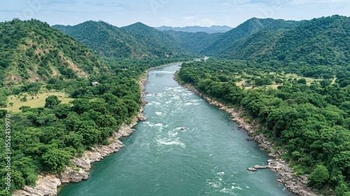 Lush riverbanks wind through a valley of hills.