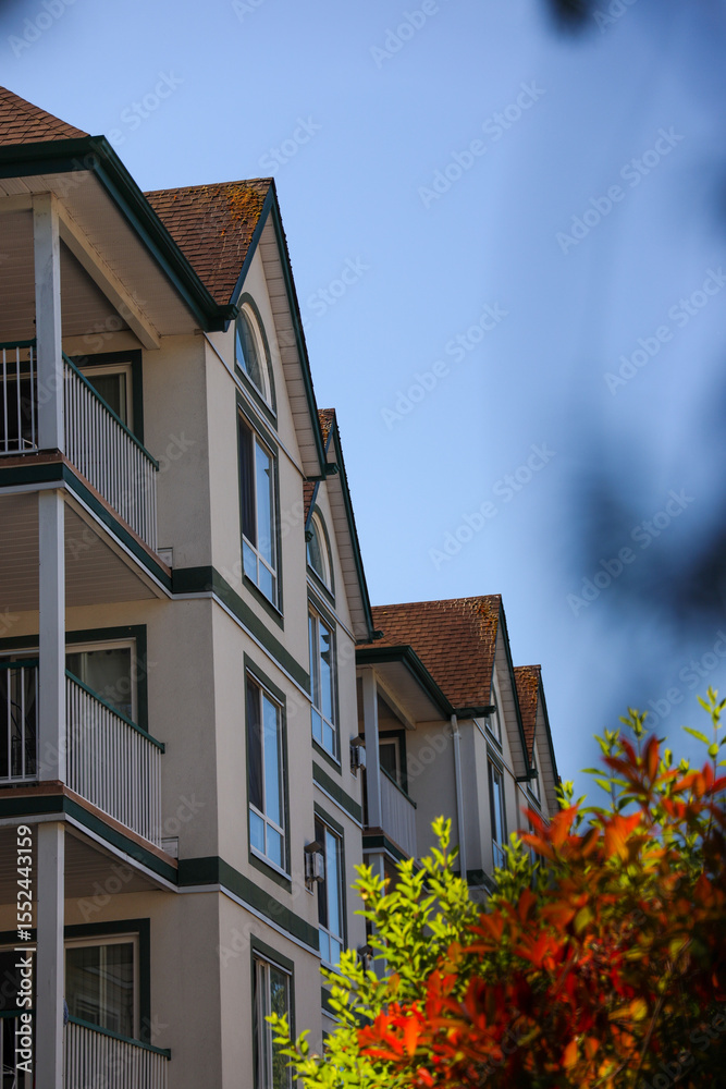 Apartment building seen from the side with trees to the side Apartment building seen from the side with trees to the side