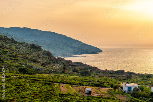 Sunset colorful landscape on Agia Kyriaki thermal hot springs village on Ikaria island, Greece fishing village of Almyrida, Greek longevity blue zone