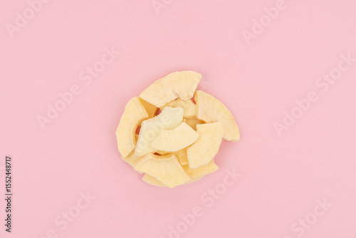 Dried Apple Slices on Pastel Pink Background – Healthy Snack Concept
