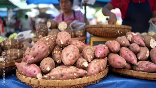 Close up view of freshly harvested sweet potatoes in baskets at open air market