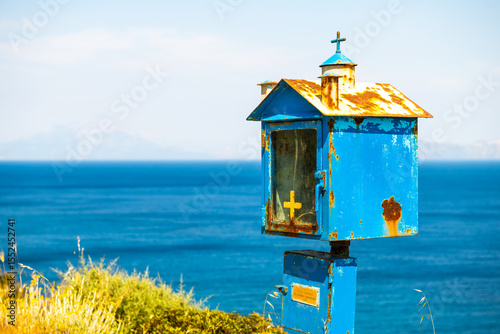 Agios Kirykos coast and worship box for Church of Analipsi The Ascension Greek christian orthodox religion at Therma, Ikaria island, Greece blue zone