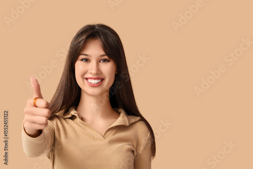 Smiling young woman showing...