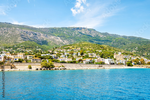 Agios Kirykos blue water waterfront cityscape panorama by Icarian sea and church on Ikaria, Greece Greek blue zone island from ferry view