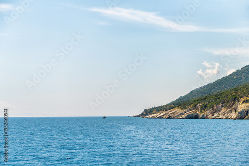Icarus or Ikarus rock mythological landmark on coast of Ikaria, Greece longevity blue zone Aegean island, view from ferry on Icarian sea