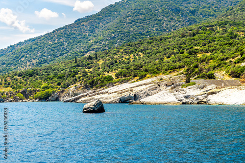 Icarus or Ikarus rock mythological myth landmark on coast of Ikaria, Greece longevity blue zone Aegean island, view from ferry on Icarian sea