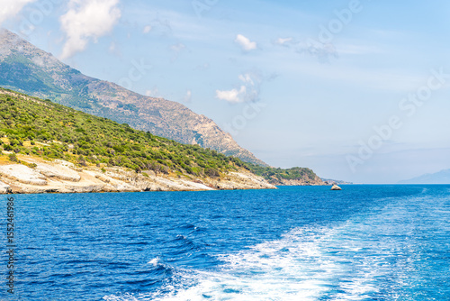 Icarus or Ikarus rock mythological landmark on coastline of Ikaria, Greece longevity blue zone Aegean island, view from ferry on Icarian sea