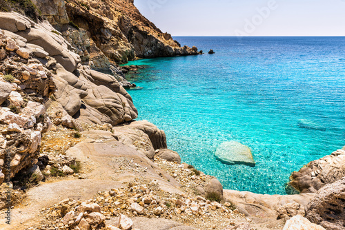 Seychelles beach at Magganitis, Ikaria island Greece, Icarian sea with crystal clear green turquoise water rocky cliffs coast high angle view