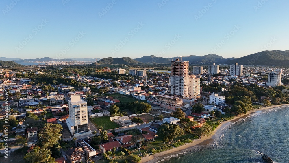 Fototapeta premium First light touches the ocean as the day begins — golden skies, calm seas, and nature in perfect balance along the Brazilian coast.