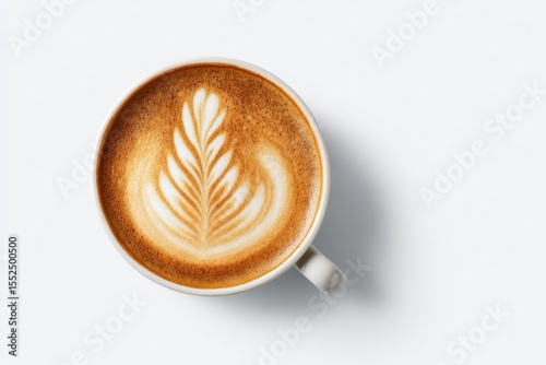 Overhead view of a light beige cup of latte art coffee, featuring a detailed leaf design in the frothed milk atop a light brown espresso base, set against a bright white background